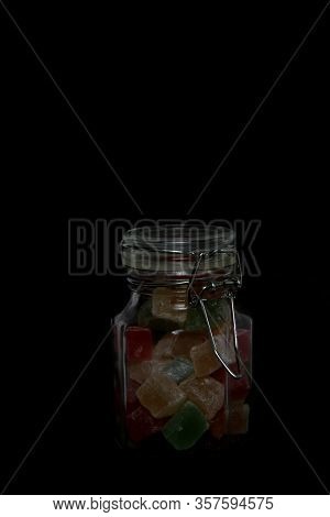 Glass Can Of Turkish Delight With Swing Stoppe Isolated On Black Background. Vertical Image. Image C