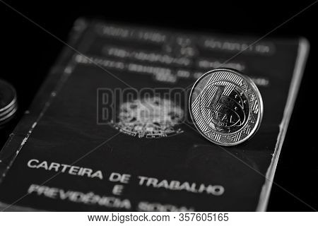 One Real Coin On An Old Brazilian Work Card. Concept Of Economic Recession And Unemployment, Social