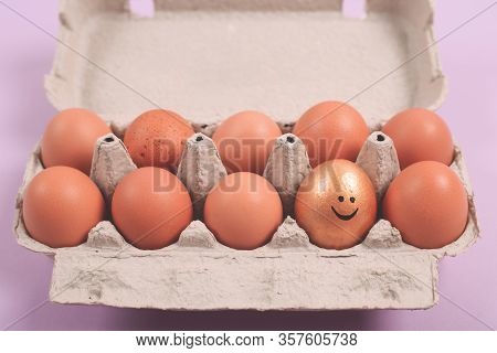 Smily Face On Golden Egg. Raw Chicken Eggs In An Open Egg Carton. Natural Healthy Food And Organic F