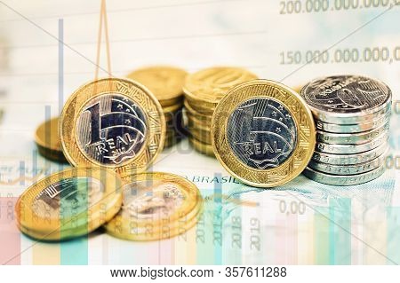 Currency Of A Real Of Brazil, With Background Of Graphs And Arrows, Concept Of Brazilian Economy In