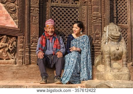 Beautiful Woman With Old Man On Traditional Clothes At Bhaktapur In Nepal