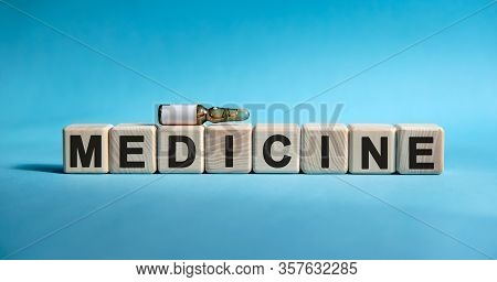 Medicine - Text On Cubes. Drug In Ambula To Reduce Disease Symptoms On A Blue Background