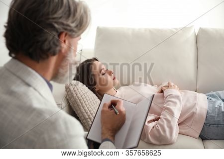 Psychotherapist And Patient In Office. Hypnotherapy Session