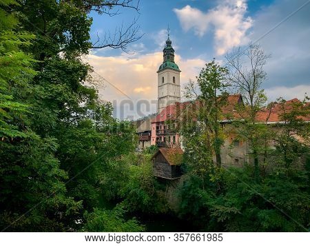 Scenic View Of Skofja Loka Church And Old Houses With Green Foliage, Slovenia