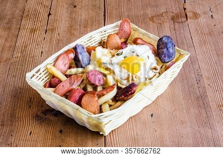Salchipapa, Roasted And Sliced Fresh Peruvian Pork Sausage, Fried Potato On Wooden Background