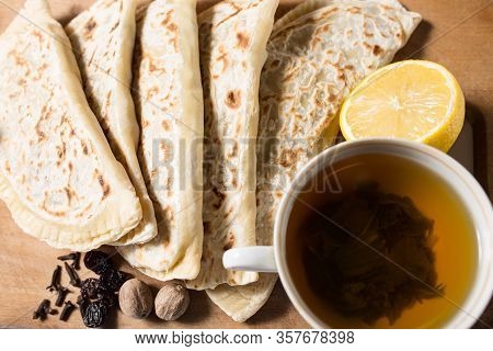 Panless Pan With Fruit And Spices Fried In A Pan. Tortilla With Fruit And Tea On A Wooden Table