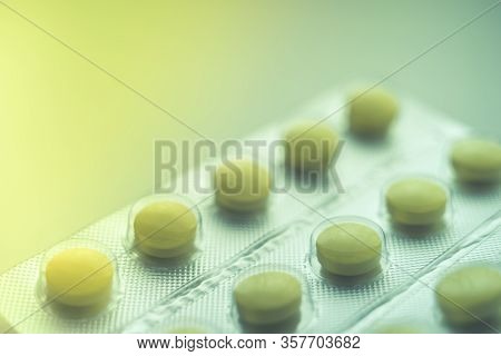 Blister With Yellow Vitamins On The Table, One Vitamin Is Already Eaten, Close-up, Side View