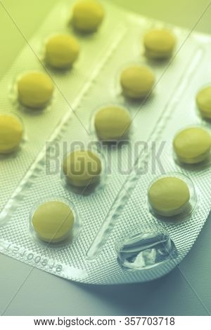 Blister With Yellow Vitamins On The Table, One Vitamin Is Already Eaten, Close-up, Side View