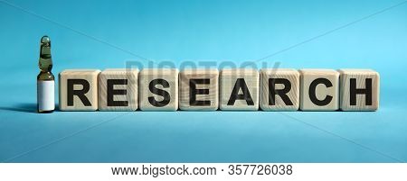 Research - Word On Cubes. Drug In Ambula To Reduce Disease Symptoms On A Blue Background