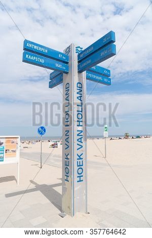 Hoek Van Holland, Netherlands - May 21, 2018: Sign Post On The Beach With The Distance To Several Fa