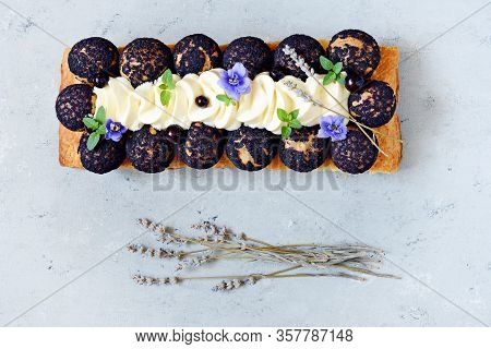 Dessert Saint Onore. Berry Pie. Puff Pastry Tart With Profiteroles, Butter Cream, Black Currant Jam 