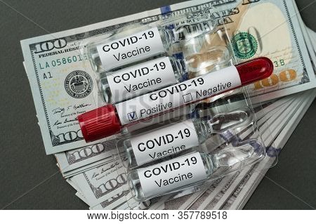 Test Tube With Blood For Covid-19 Analyzing And Ampoules Of Vaccine Are On Stack Of Dollars. Price D