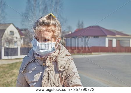 A Child With White Hair In A Jacket And Medical Mask. Prohibition Of School Attendance. Insulation.