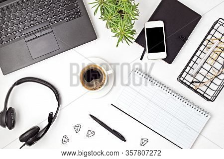 Top View Of Office Desk. Table With Laptop, Conference Speakerphone And Office Supplies. Flat Lay Ho