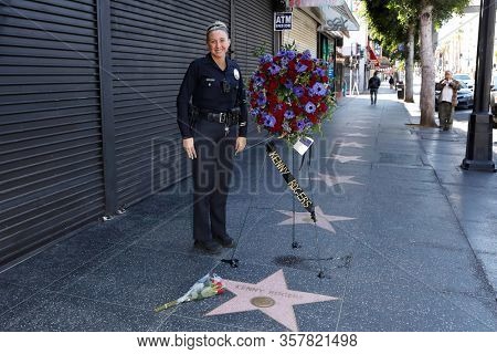 LOS ANGELES - MAR 21: LAPD officer Yest as a wreath is placed at the star of Kenny Rogers on the Hollywood Walk of Fame on March 21, 2020 in Los Angeles, CA. Rogers died late Friday at the age of 81.