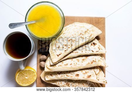 Home Made Tortilias With Nuts And Honey Om A Wooden Board