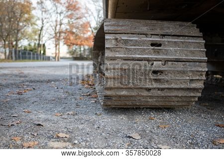 Low Angle Closeup View Of Bulldozer Track Grouser Pad And Roller