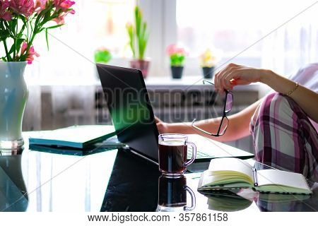Cropped Image Of A Girl Or Woman Working On Quarantine From Home On The Kitchen Wearing Pijama.home 