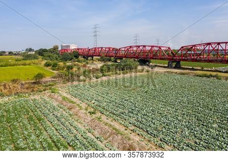 red famous Xilou Bridge over the river and farm in Yunlin county, Taiwan