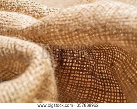 Crumpled Baline, Close Up View, An Abstract Background. Texture Of Brown Burlap Textile. Brown Sackc