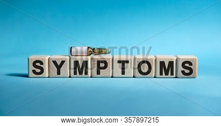 Symptoms - Word On Cubes. Drug In Ambula To Reduce Disease Symptoms On A Blue Background