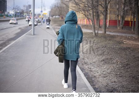 A Girl Is Walking Around The City. A Teenager Walks Alone. Unknown Person In The Hood. The Man Did N