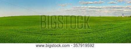 Panoramic View Of Beautiful Green Field Hils With Blue Sky At Spring