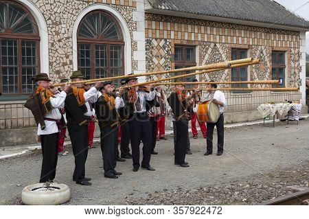 Yasinya, Ukraine - September 29, 2016: Hutsuls In National Costumes With Folk Instruments Meet The G