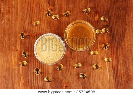Gelatin in bowls on wooden background close-up
