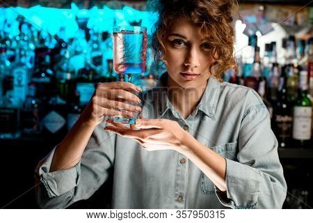 Pretty Lady Barman Holds Glass In Her Hands.