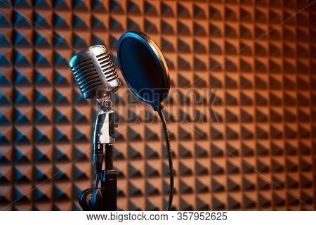 Retro Microphone And Pop Filter On Acoustic Foam Panel Background