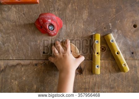 The Child Is Engaged In Training In A Climbing Gym.
