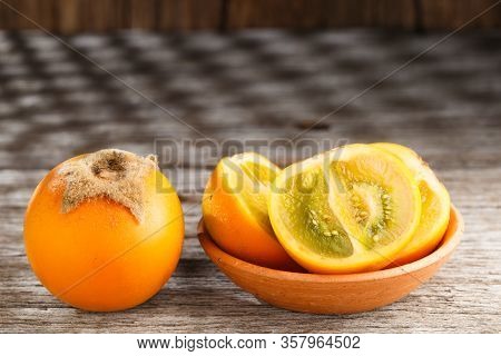 Fruit Of Lulo Or Naranjilla On Wood