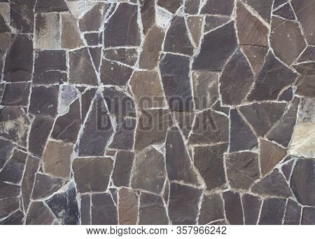 Фрагмент каменной стены сделанной из рубленного гранитного камня. Stone Wall Made Of Flat Chopped St