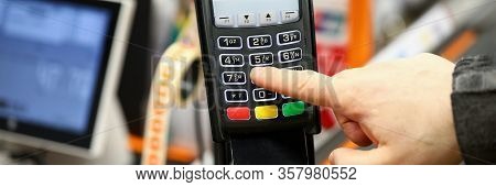 Male Hand Typing Pin Code Card While Paying With It At Cash Desk Of Supermarket Close-up