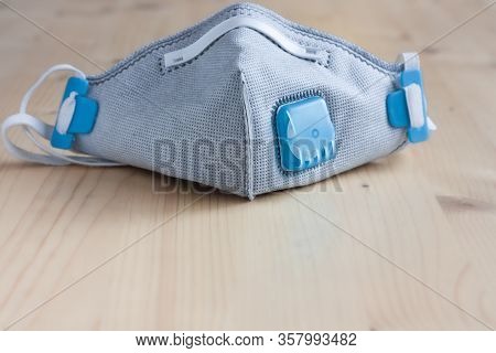 Respirator Face Mask With Heavy-duty Protective Filter On A Wooden Light Background. Madical Face Ma