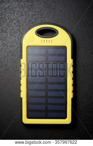 Portable solar cell on a black table.