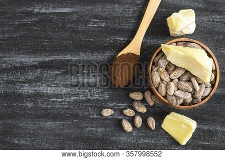 Cocoa Butter Or Cocoa Bean Solid Oil With Cacao Powder In Spoon Or Bowl And Raw Cocoa Beans On Rusti