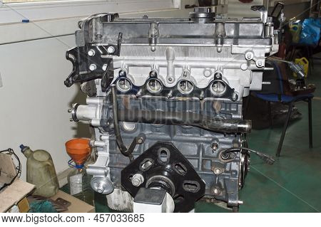 The Assembled Four-cylinder Automobile Internal Combustion Engine Is Installed On The Engine Repair 