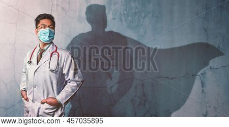 Brave Doctors With His Shadow Of Superhero On The Wall. Concept Of Powerful Man