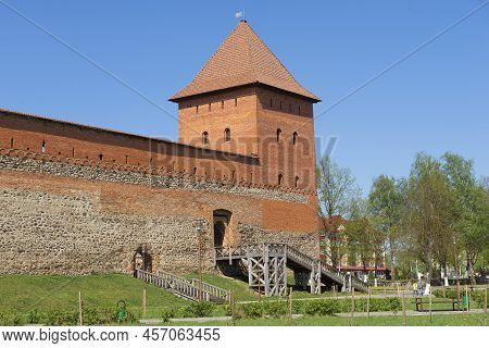 Fragment Of The Wall And Defensive Tower Of The Lida Castle On A Sunny April Day. Lida, Belarus