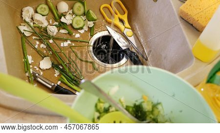 Organic Garbage In Sink With Built-in Food Waste Disposer. Vegetable Or Fruits Peels, Remains And Le