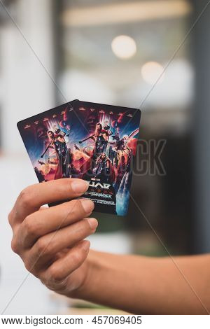 Samut Prakan, Thailand - June 26, 2022: Man Hand Holding Tow Card Of Thor Love And Thunder Collectio