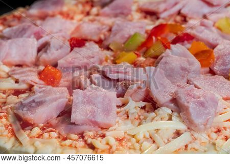 Uncooked Pizza With Ham, Pepper, Cheese, Sause In Electric Oven - Close Up Macro View. Italian Cuisi