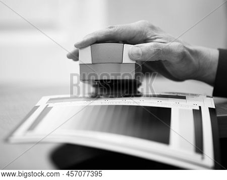 Man Calibrates Photo Paper Before Printing Photography