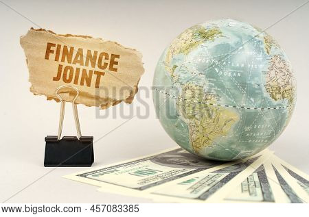 Business Concept. On A Gray Surface, A Globe, Dollars And A Cardboard Plate With The Inscription - F
