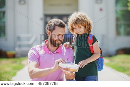 School Boy Going To School With Father. Schoolboy And Parent In Shirt Holding Lunch Box. School Lunc