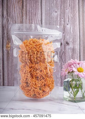 Side View Of Sweet And Sour Crispy Noodles (or Mee Krob In The Thai Language) In A Clear Package Pla
