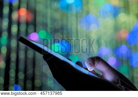 Woman Hands Using Smartphone Device At Interactive Exhibition Or Museum With Colorful Illumination: 