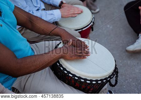 Drumming Close-up, A Black Guy Beats The Rhythm On A Djmba, A Street Musician Performing In Front Of